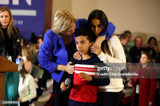 Democratic presidential candidate Sen. Elizabeth Warren hugs her grandchildren Atticus Tyagi and Lavinia Tyagi during her caucus night watch party on...