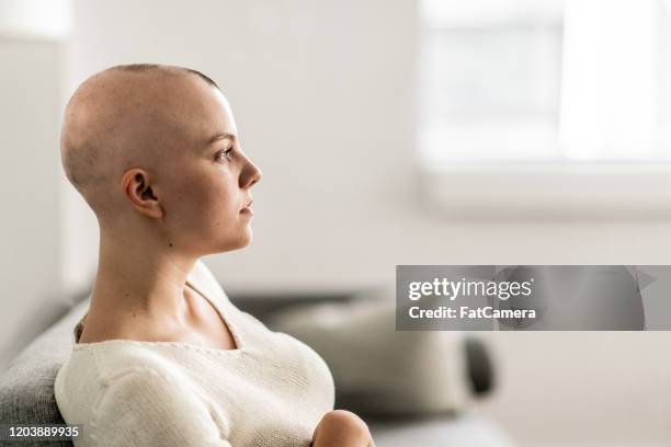 profile of young woman with alopecia sitting casually stock photo - patient profile stock pictures, royalty-free photos & images