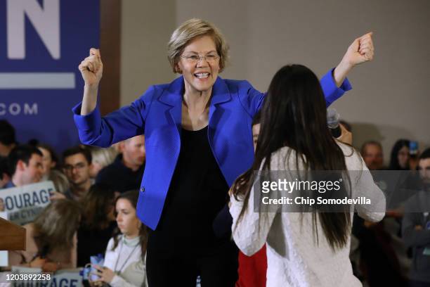 Democratic presidential candidate Sen. Elizabeth Warren celebrates with her grandchildren Atticus Mann Tyagi and Lavinia Tyagi during her caucus...