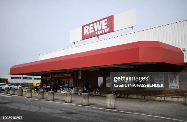 Picture taken on February 28, 2020 shows the entrance of a Rewe supermarket in the western German village of Heinsberg. - Around 1,000 people were in...