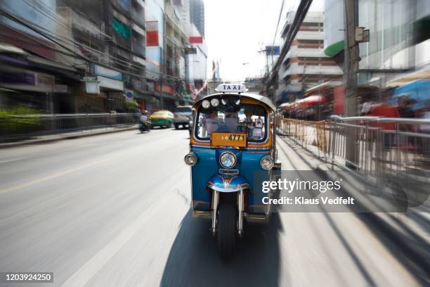 speeding jinrikisha on road - tuk tuk stock-fotos und bilder