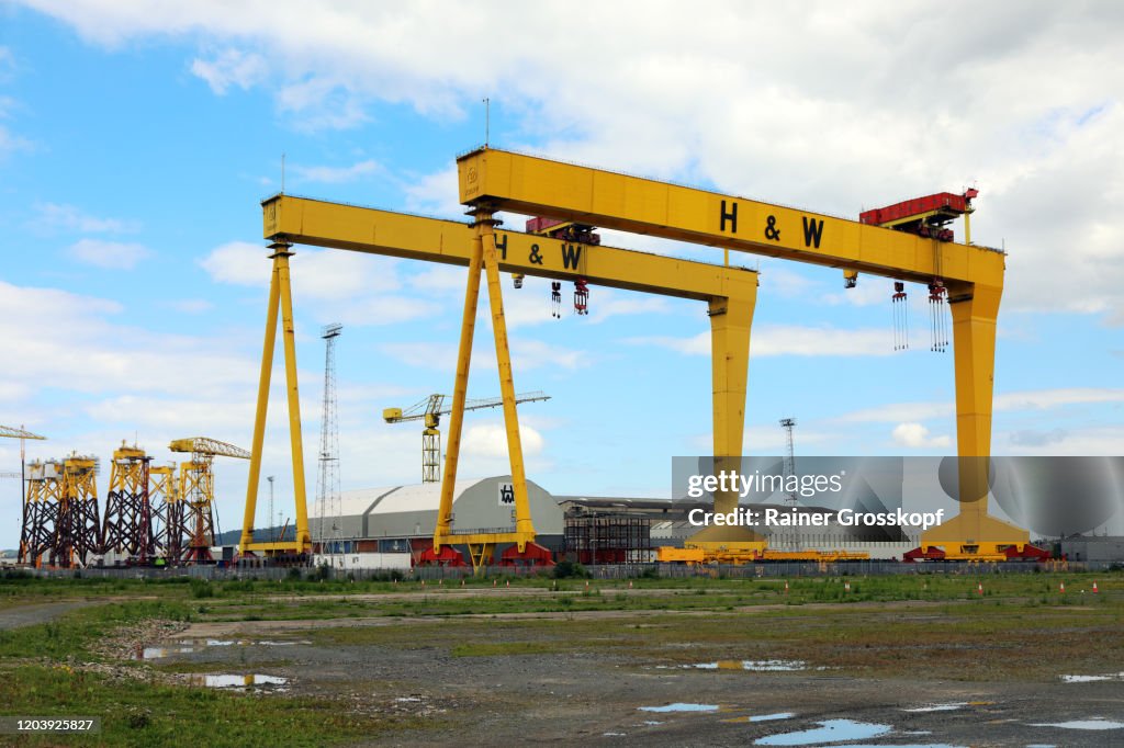 Two yellow cranes of the H & W shipyard against the sky