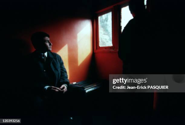 Valparaiso in Chile - A young business man enjoy the sunlight that manage to penetrate inside a funicular small window.