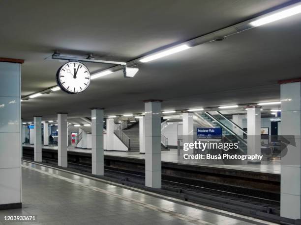 clock inside potsdamer platz subway station in berlin, germany - berlin subway stock pictures, royalty-free photos & images