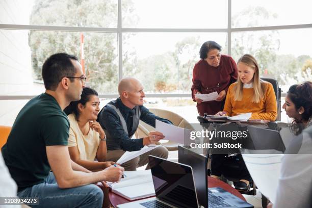 grupo diverso de científicos en la discusión en grupo - reunion de personal fotografías e imágenes de stock