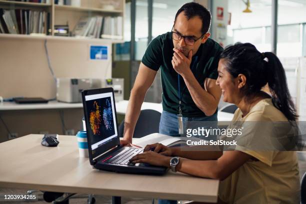 two colleagues work together - genomics stock pictures, royalty-free photos & images