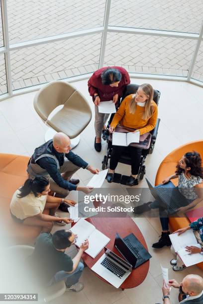 diverse team meeting - aerial view business stock pictures, royalty-free photos & images