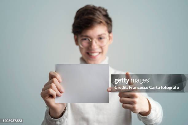 man holding empty paper - holding photo stock pictures, royalty-free photos & images