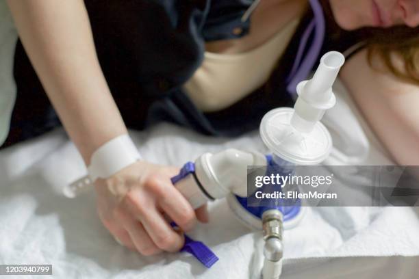 woman in labour at hospital using nitrous oxide for pain relief - nitrous oxide hospital stock pictures, royalty-free photos & images
