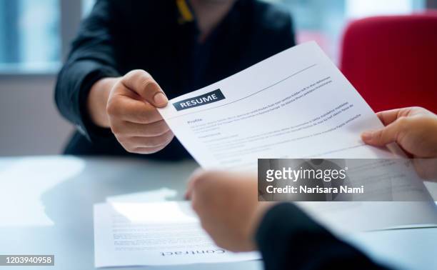recruitment, job application, contract and business employment concept. hand giving the resume to the recruiter to review the profile of the applicant. - bewerbungsformular stock-fotos und bilder