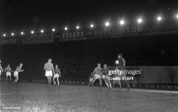 Yugoslav goalkeeper Vidinic catches the ball under pressure from a Soviet forward during the first-ever European Nations soccer championship final 10...