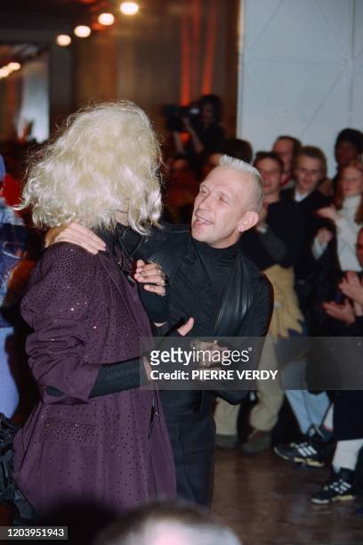 French designer Jean-Paul Gaultier embraces a model smoking during the men's ready-to-wear Fall/Winter 1995/96 collection fashion show, on January...
