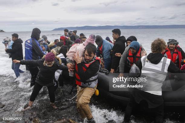 Irregular migrants escaped from civil war in Syria, who want to proceed to Europe, arrive with a boat at a shore in Lesbos Island on Greece on...