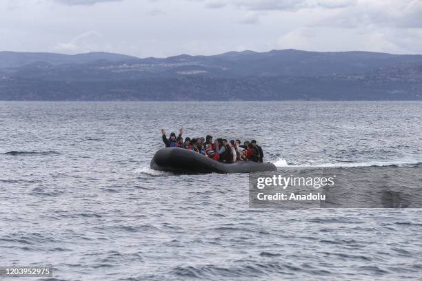 Irregular migrants escaped from civil war in Syria, who want to proceed to Europe, arrive with a boat at a shore in Lesbos Island on Greece on...