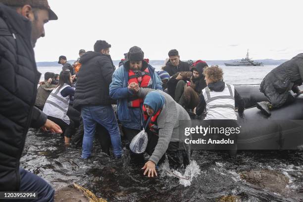 Irregular migrants escaped from civil war in Syria, who want to proceed to Europe, arrive with a boat at a shore in Lesbos Island on Greece on...