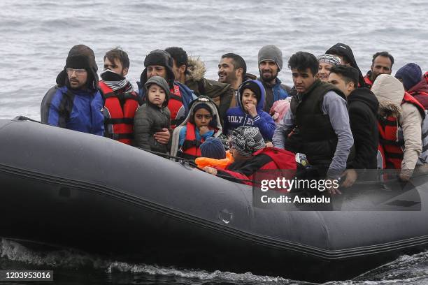 Irregular migrants escaped from civil war in Syria, who want to proceed to Europe, arrive with a boat at a shore in Lesbos Island on Greece on...