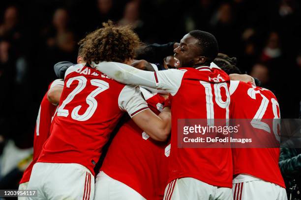 Pierre-Emerick Aubameyang of Arsenal FC celebrates after scoring his team's first goal with teammates during the UEFA Europa League round of 32...
