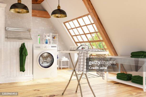 waschraum mit waschmaschine und eisen - waschsalon stock-fotos und bilder