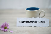 You are stronger than you think, a paper note with morning coffee.