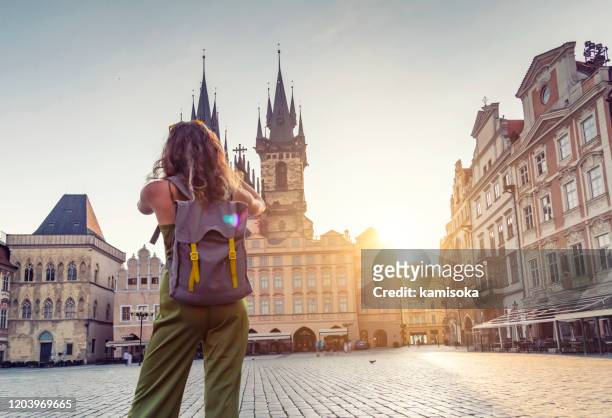 young woman taking photo from the tyn church in prague - prague photos et images de collection
