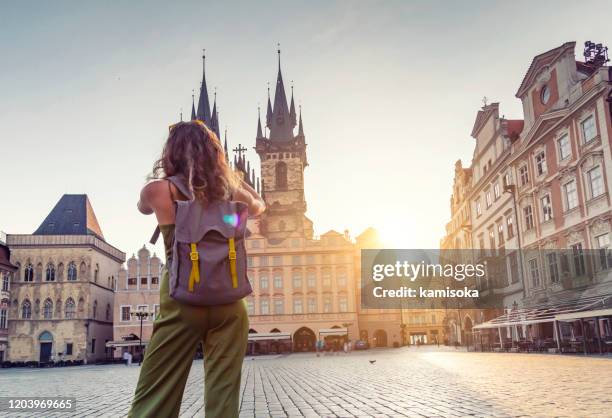 young woman taking photo from the tyn church in prague - prague people stock pictures, royalty-free photos & images