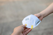 Hand give to / grant / assign / deliver N95 mask or respirator for protect PM 2.5 to other