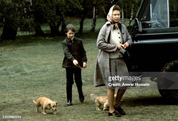 Queen Elizabeth ll and Lady Sarah Armstrong-Jones walk with pet corgis, which are a cross between a corgi and a dachshund, at the Badminton Horse...
