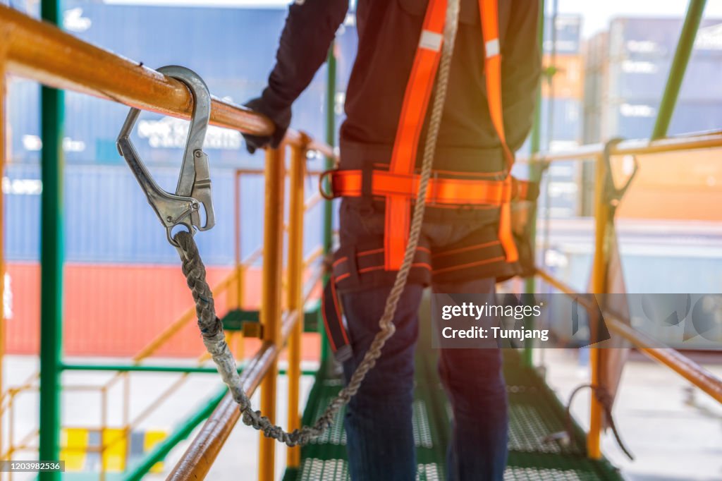 Construction worker use safety harness and safety belt working for high rise site project.