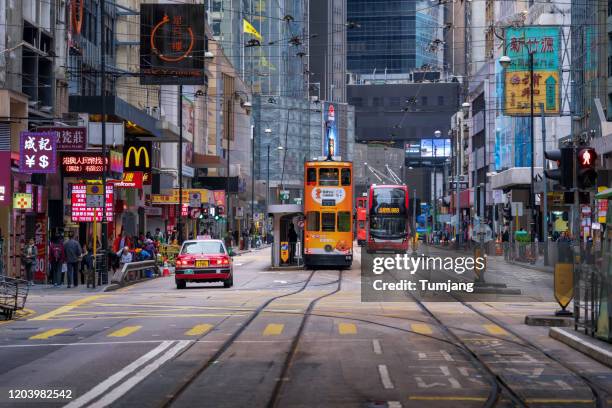 railway of hongkong tramway near the international finance centre, abbreviated as ifc (branded as "ifc") is a skyscraper and an integrated commercial development of hong kong's central district. - hong kong foto e immagini stock