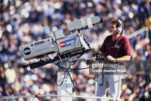 An American Broadcasting Company ABC commercial broadcast television cameraman using a Fujinon A55 9.5 IE television camera during the American...