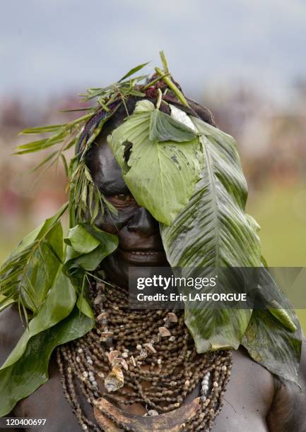 Mourning woman from Highlands in Papua New Guinea - She has put some sump oil on her body.