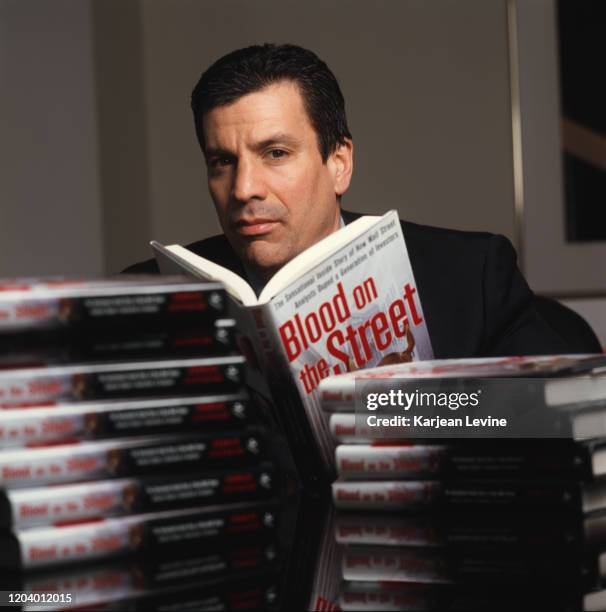 Charles Gasparino, a senior writer for Newsweek, poses for a portrait with copies of his new book, “Blood on the Street: The Sensational Inside Story...