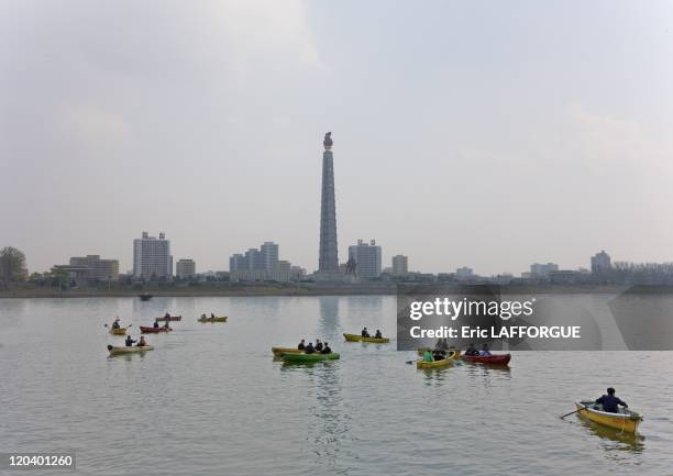 Boats on Tadeong River in Pyongyang, North Korea - This a major attraction on sunday in Pyongyang. People have to put an old tyre as lifesaver. In...