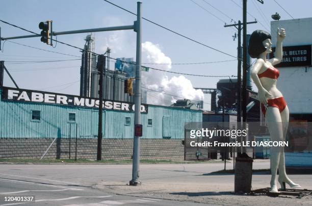 Peoria, Illinois, United States - A factory with a statue of a woman in a bathing suit
