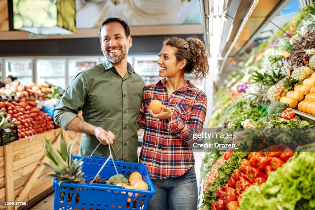 Latino couple buying vegan food
