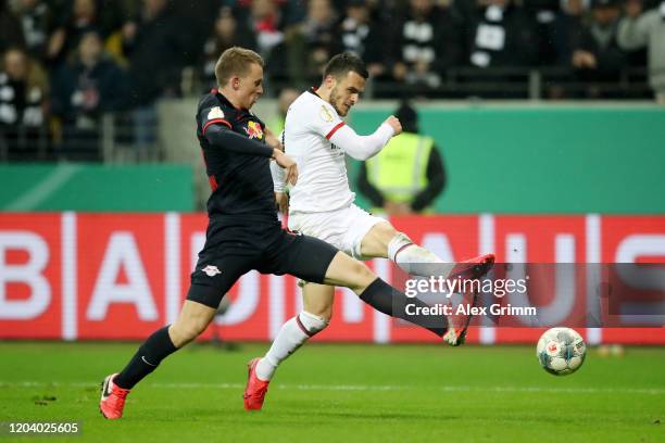 Filip Kostic of Eintracht Frankfurt scores his sides fifth goal past Lukas Klostermann of RB Leipzig during the DFB Cup round of sixteen match...
