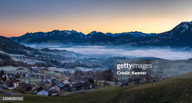 dawn at cold morning with fog - vorarlberg stock pictures, royalty-free photos & images