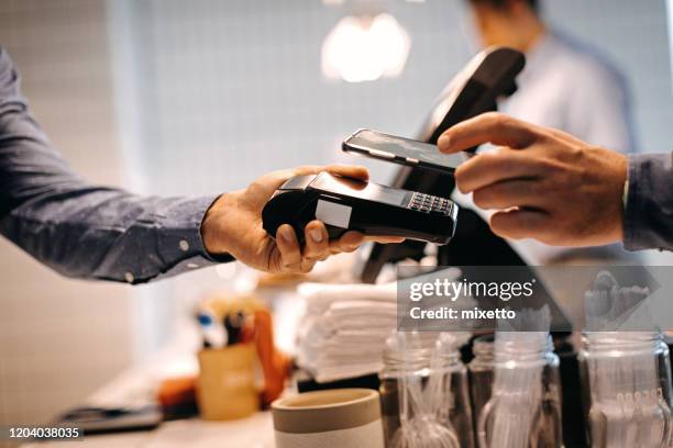 customer making a contactless payment - digital lockbox stock pictures, royalty-free photos & images