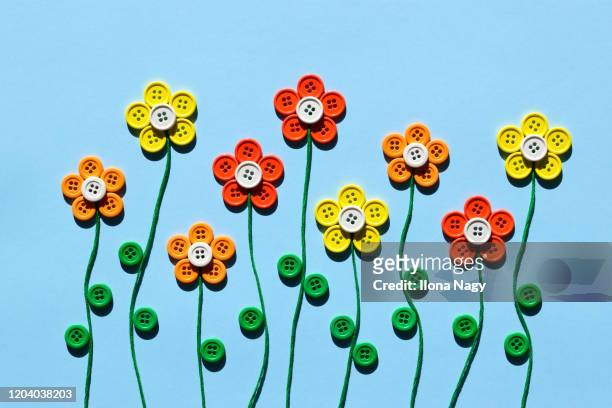 flowers made of colorful buttons - button sewing item stock pictures, royalty-free photos & images