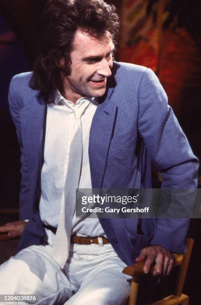 English Rock & Pop musician Ray Davies, of the group the Kinks, sits in a director's chair during an interview at MTV Studios, New York, New York,...
