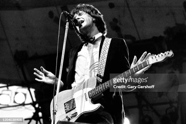 English Rock & Pop musician Ray Davies, of the group the Kinks, plays guitar as he performs onstage during the Dr Pepper Central Park Music Festival,...