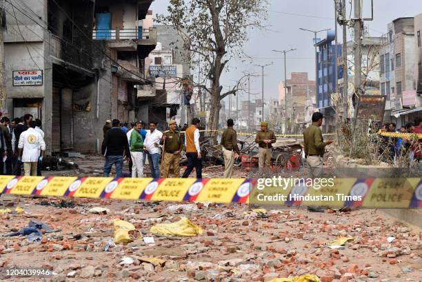 Security personnel stand guard at a street following Tuesday's violence over the Citizenship Amendment Act , at Karawal Nagar on February 28, 2020 in...