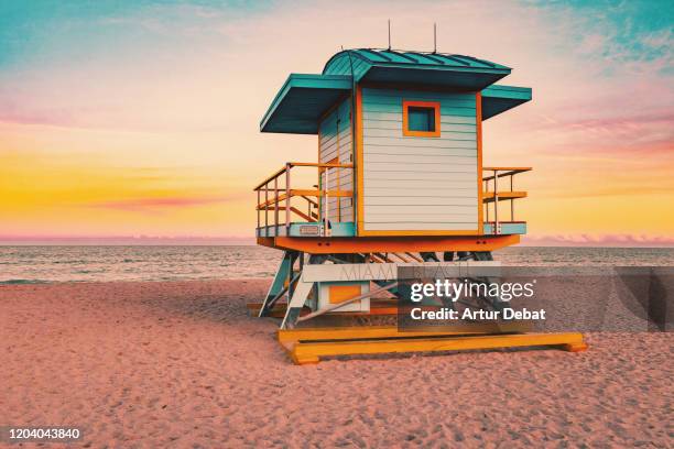 colorful miami beach lifeguard tower with stunning sunset sky and empty beach. - miami beach ストックフォトと画像