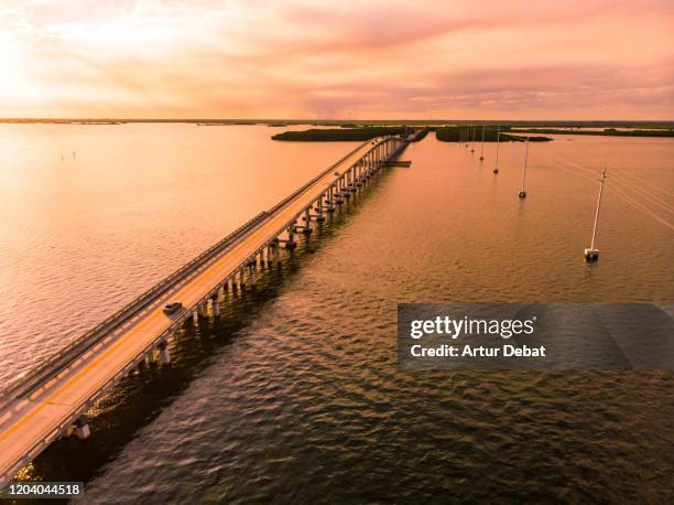 drone view of the overseas highway in florida keys during sunset. - overseas highway stock pictures, royalty-free photos & images