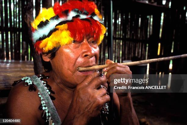 The world of Jivaro Indians in Ecuador in 1993 - Tuutinensa Shaman playing the Jew's harp- Shuar ethnic group- Ecuadorian Amazon.