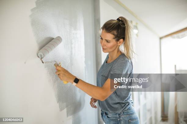 woman doing diy project in apartment - whitewashed stock pictures, royalty-free photos & images