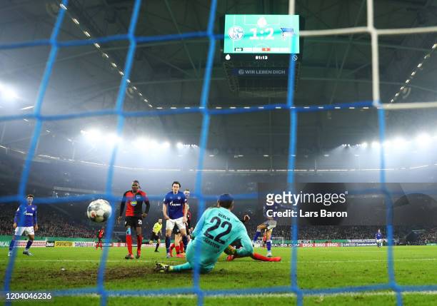Amine Harit of FC Schalke 04 scores his team's second goal past Rune Jarstein of Hertha BSC during the DFB Cup round of sixteen match between FC...