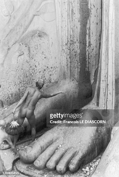 Shravanabelagola, India in 2006 - A naked Jain monk at Karnakata, in front of the feet of the statue of Bahubali during the ceremony of...