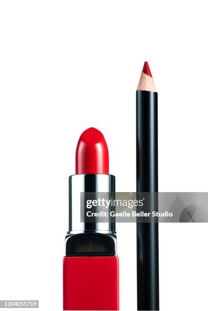 fashionable red lipstick and pencil against white background - konturstift stock-fotos und bilder