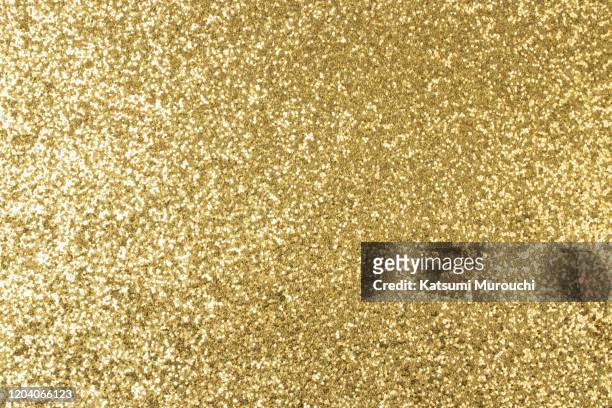 gold glitter texture background - gold coloured stock pictures, royalty-free photos & images